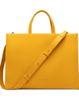 Tote Bag in saffron with the detachable shoulder strap on a white background.