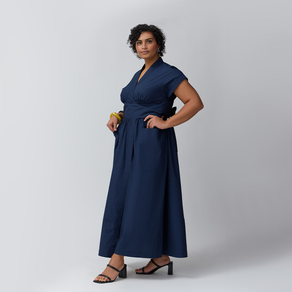 A model in the midnight showing the side of the dress.