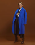 Carla wearing the Indispensable Car Coat Wool Blend in Cobalt posing on the side.