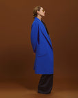Close-up of Carla wearing the Indispensable Car Coat Wool Blend in Cobalt.