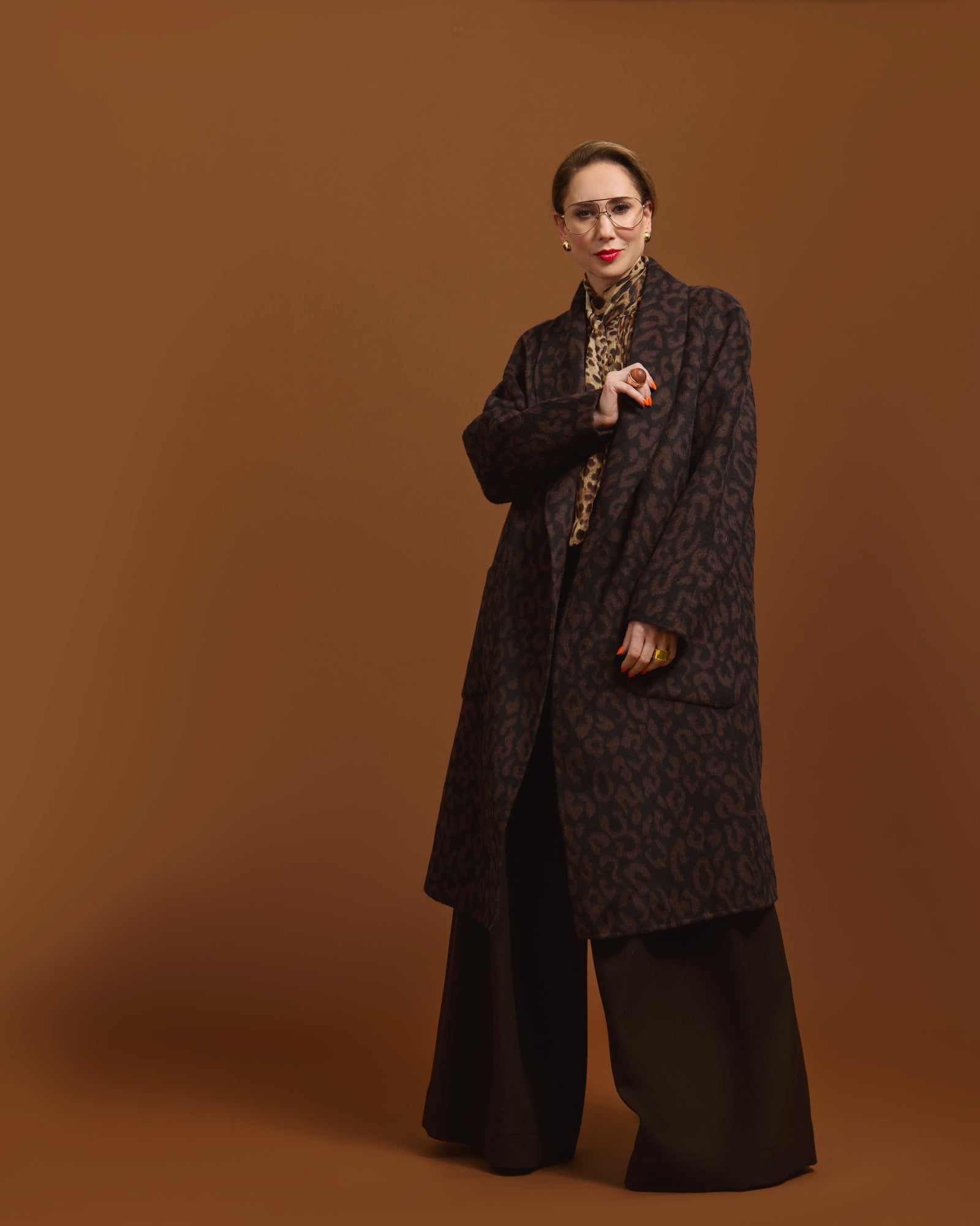 Person wearing the Leopard Jacquard coat with a pattern on a brown background.