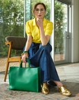 Carla Rockmore modeling the 2-in1- tote bag in emerald green.