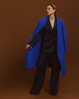 Carla wearing the Indispensable Car Coat Wool Blend in Cobalt in a black jacket and pants.
