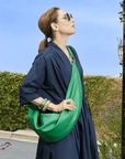Carla Rockmore is modeling the Emerald Green bag on midnight dress.