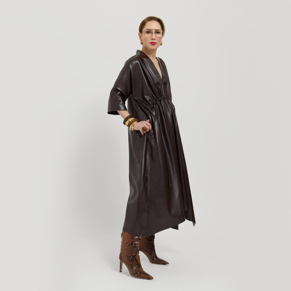 Carla wearing the chocolate brown loose in the waist on a white background.