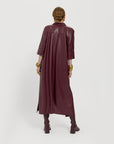 Carla modeling the Merlot dress. She is showing the back not tied.