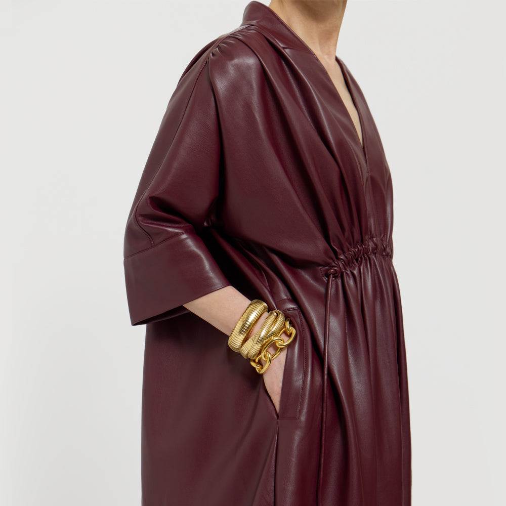 Close up of the Merlot dress on a light gray background.