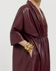 Close up of the Merlot dress on a light gray background.
