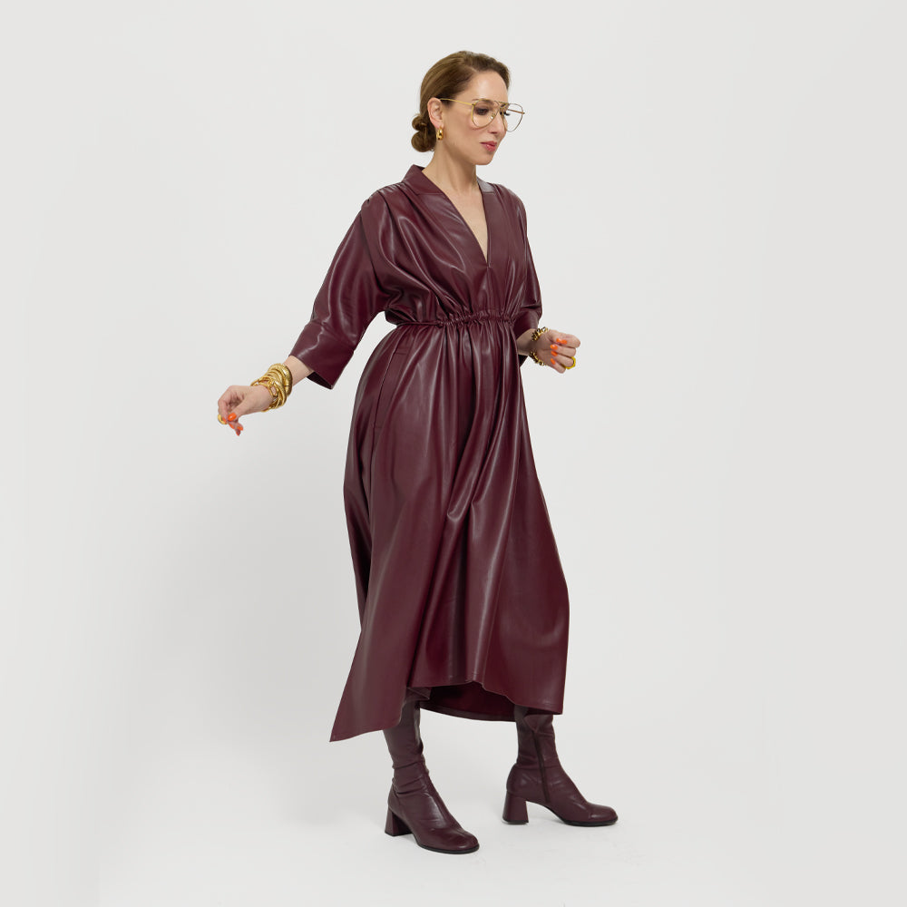 Carla is modeling the Merlot dress, showing it tied and on the side.