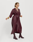 Carla is modeling the Merlot dress, showing it tied and on the side.