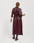 Carla modeling the Merlot dress. She is showing it tied on the back.