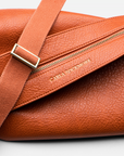 Mini Sling Bag in Burnt Sienna texture on a light gray background.