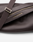 Mini Sling Bag in Chocolate with gold zipper and visible brand name on a white background.