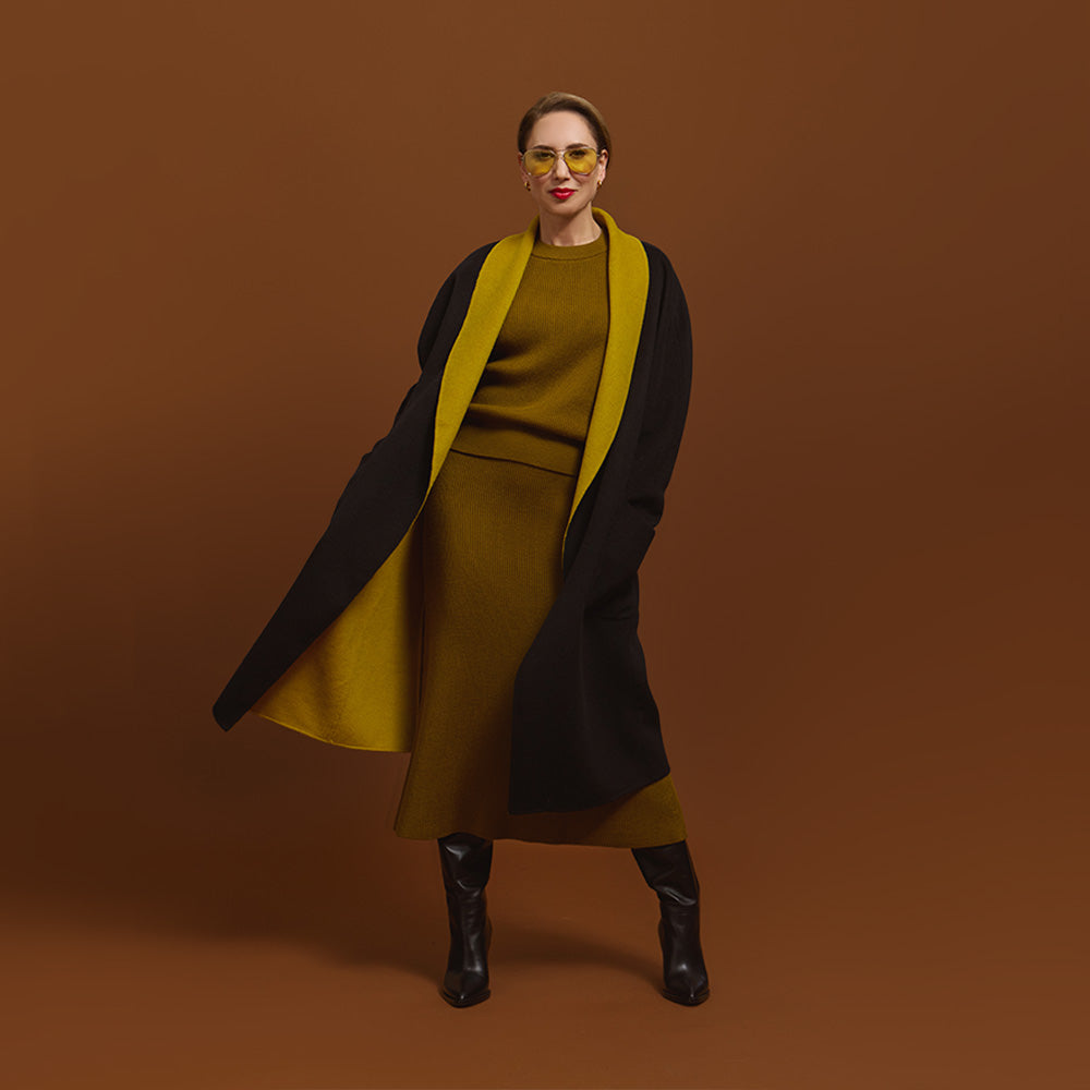 Carla modeling the coat in black and you see the inside of the coat in moss.