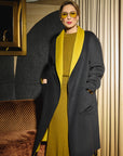 Carla modeling the coat side in Black and showing the pockets front of the coat.