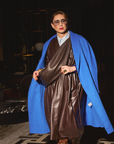 Carla wearing the coat in Cobalt and the Sling Bag in Chocolate.