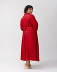Model shown from the side and slightly turned to reveal the back of the Poppy shirt dress, tied at the waist to highlight the tailored shape, with clean lines and structure.