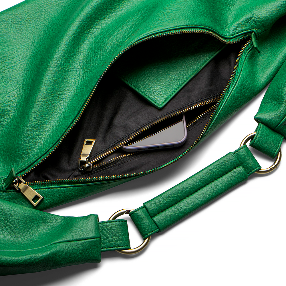 Emerald Green Sling Bag in vegan leather with open zipper showing black interior.