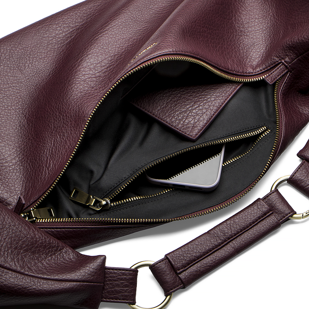 Sling Bag 3.0 in Merlot Inside Zipper Image. Merlot vegan leather  sling bag with gold zipper on a white background.