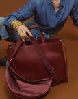 Model holding the 2-in-1 Tote bag is Cherry Cola against a brown background.
