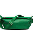 Close-up of the emerald green Mini Sling Bag’s structured front and part of the strap slightly angled forward.