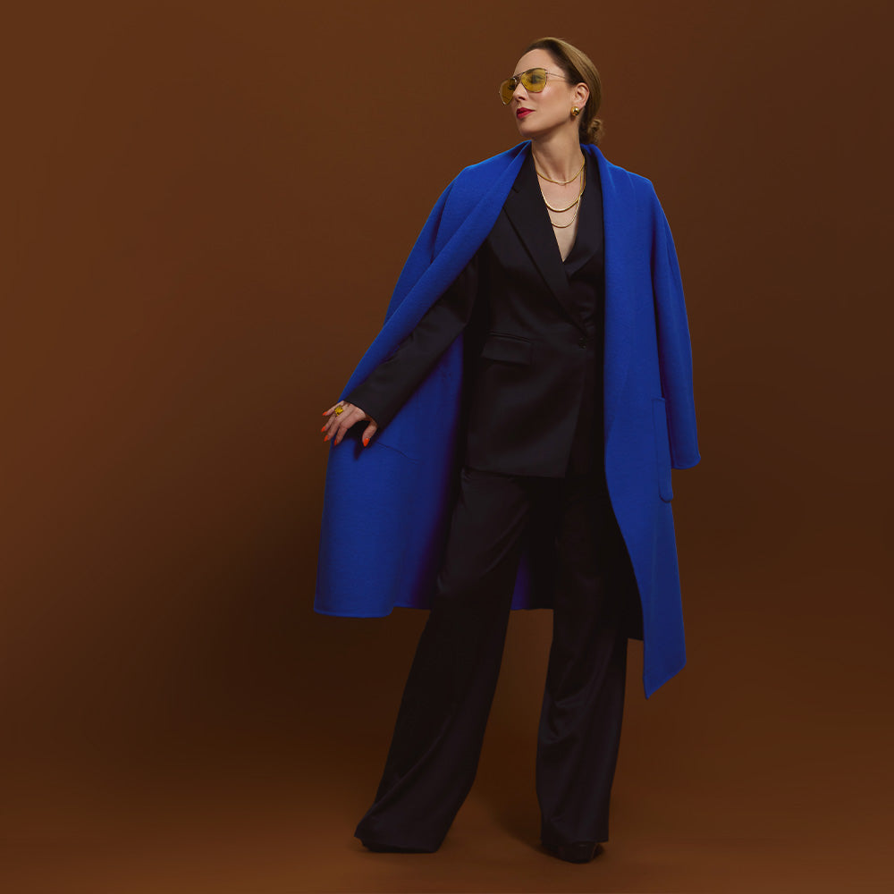 Carla wearing the Indispensable Car Coat Wool Blend in Cobalt in a black jacket and pants.