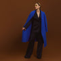 Carla wearing the Indispensable Car Coat Wool Blend in Cobalt in a black jacket and pants.