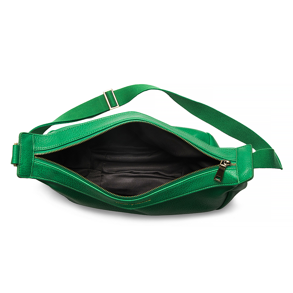 Open view of the Mini Sling Bag in Emerald Green revealing its black nylon interior lining and minimalist internal structure.