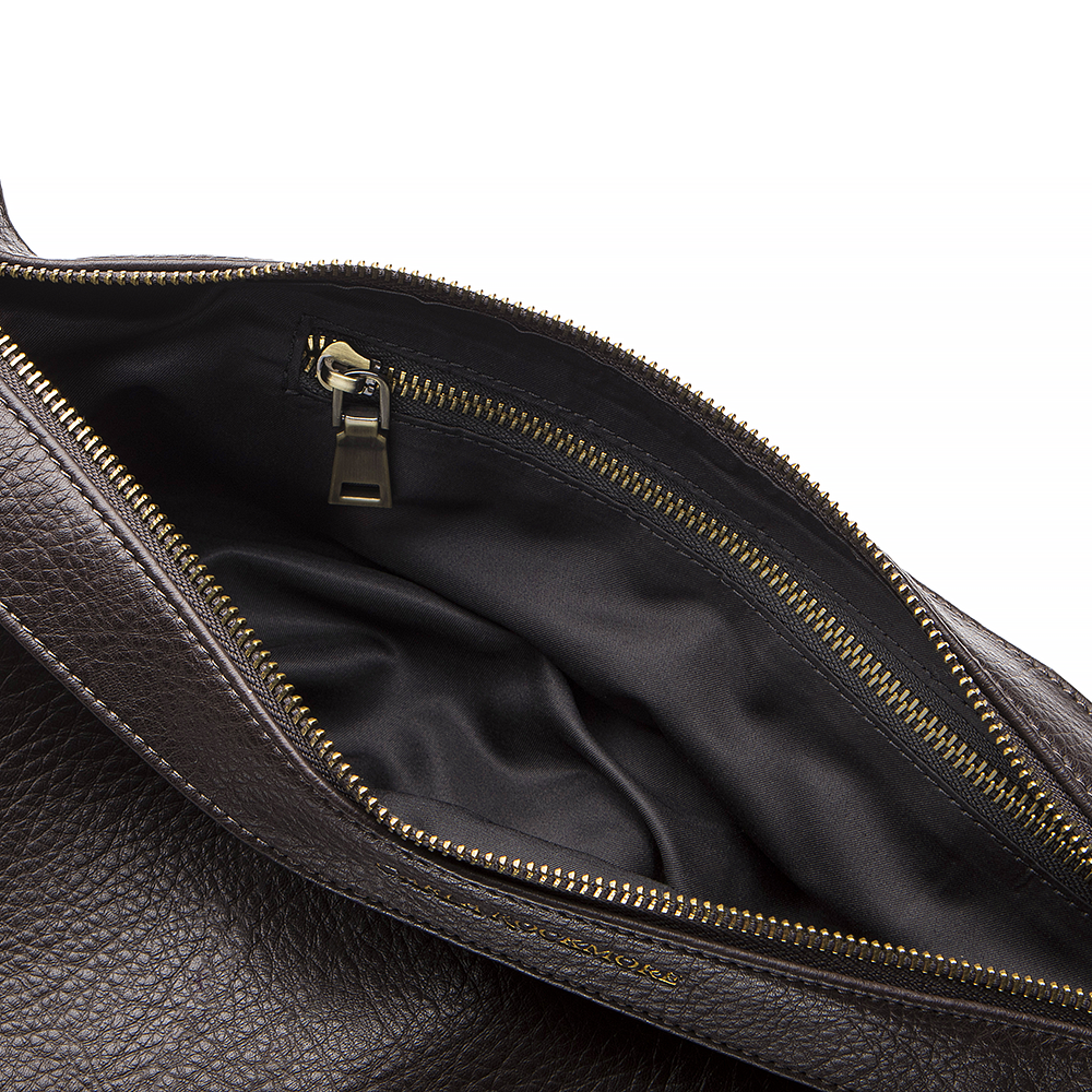 Close-up of THE bag showing the inside  zipper pocket on a white background.