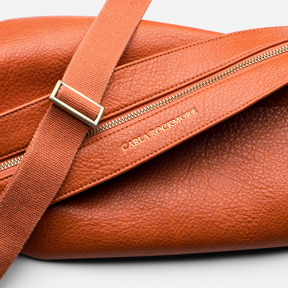 Mini Sling Bag in Burnt Sienna texture on a light gray background.