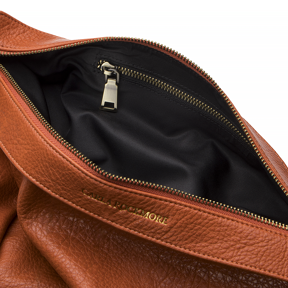 Mini Sling Bag in Burnt Sienna with inside pocket zipper on a white background.