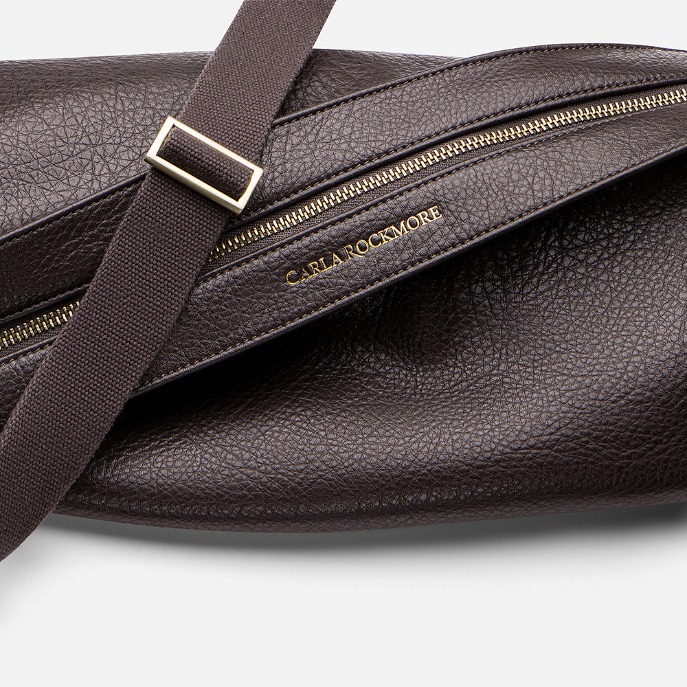 Mini Sling Bag in Chocolate  with gold zipper and visible brand name on a white background.