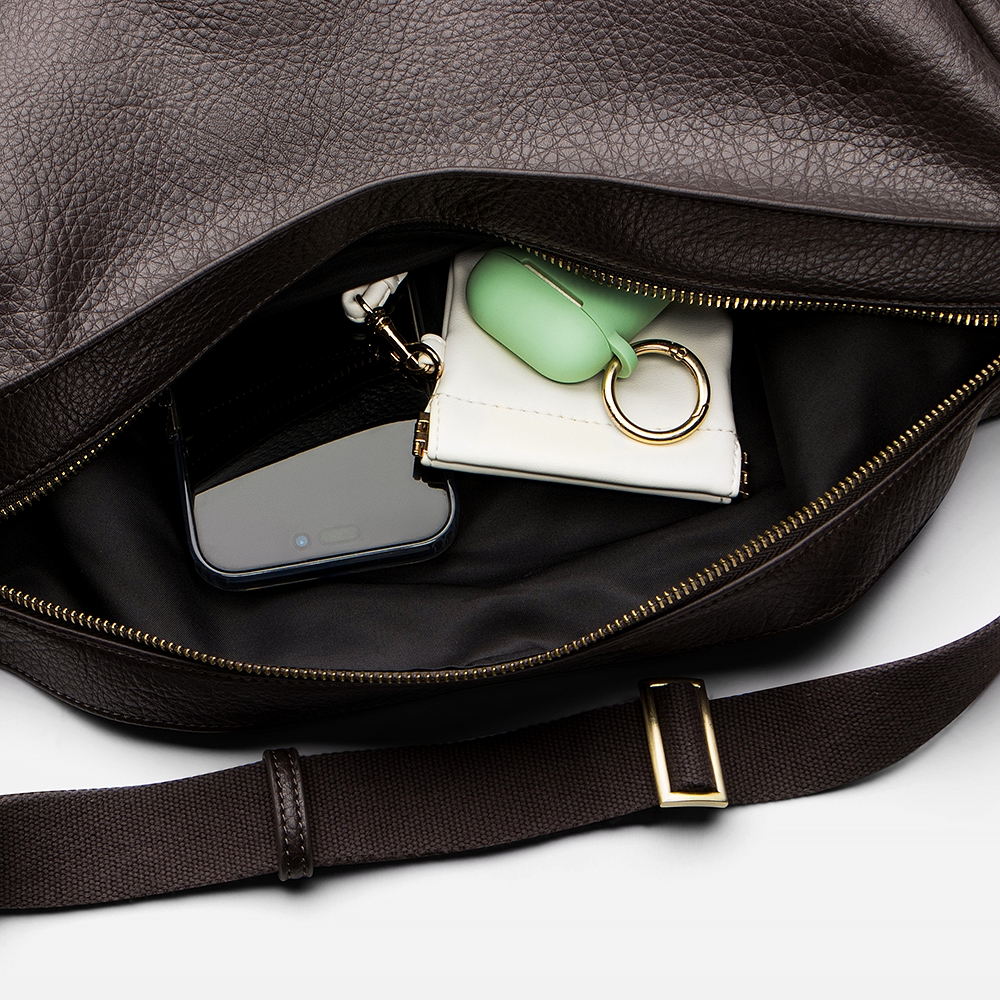 Mini Sling Bag in Chocolate with phone, wallet, and keys on a white background.
