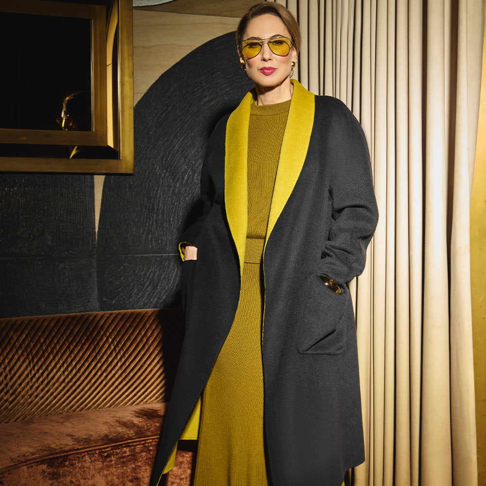 Carla modeling the coat side in Black and showing the pockets front of the coat.