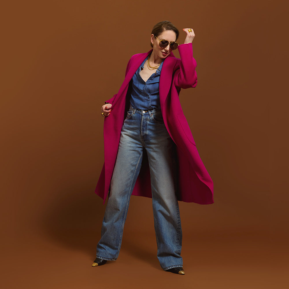 Carla wearing the Indispensable Car Coat Wool Blend in Orchid and blue jeans on a brown background.